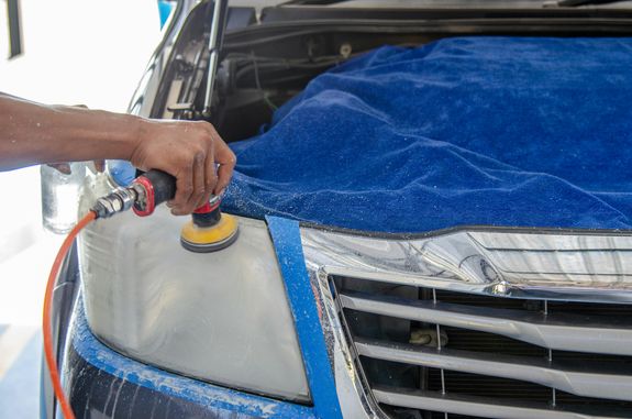  Person Using a Polishing Machine on the Car