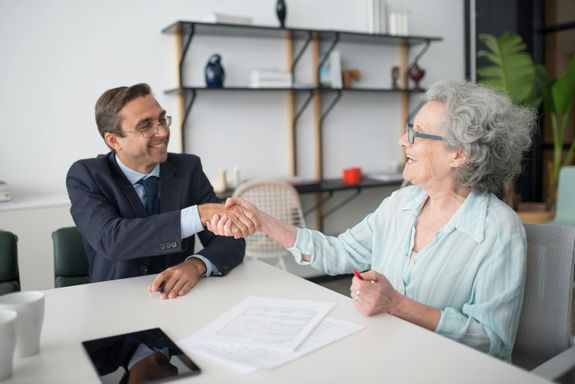 Elderly Woman Handshaking with Insurance Agent