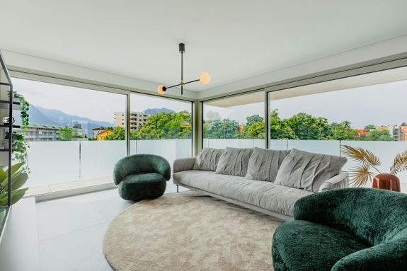 A living room with a large window overlooking the city