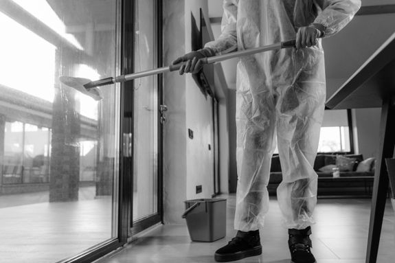 Grayscale Photo of Person Cleaning Glass Window