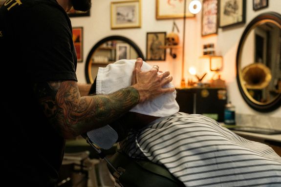 Barber Putting a Towel on the Customers Face