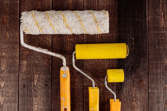 Paint Rollers on a Wooden Surface