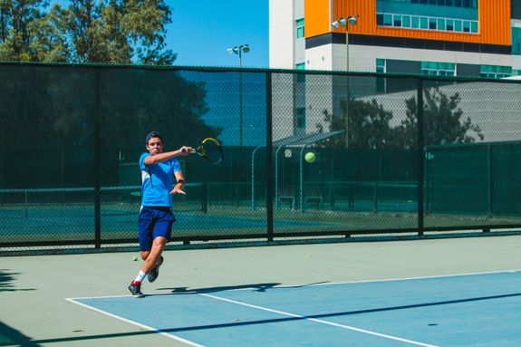 A Man Hitting a Tennis Ball