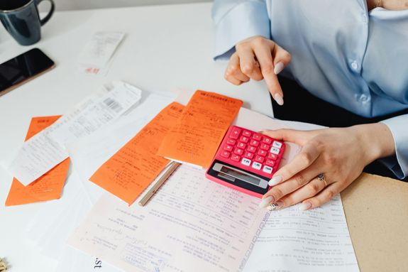 Person Holding Oink Calculator