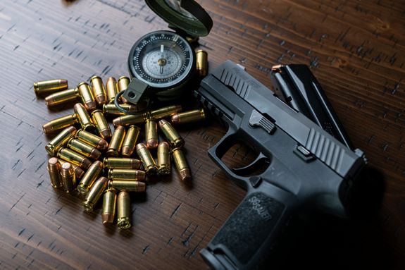 Black Semi Automatic Pistol With Gold and Silver Round Coins