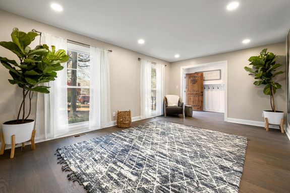 A Carpet Near the Glass Windows on a Wooden Floor 