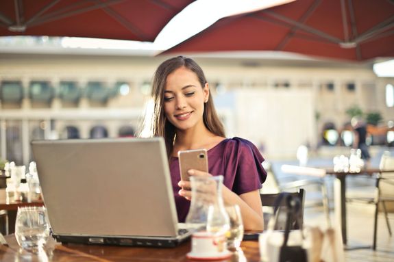 Woman Wearing Purple Shirt Holding Smartphone White Sitting on Chair