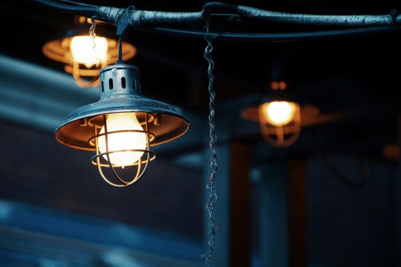 Glowing lamps on ceiling in darkness