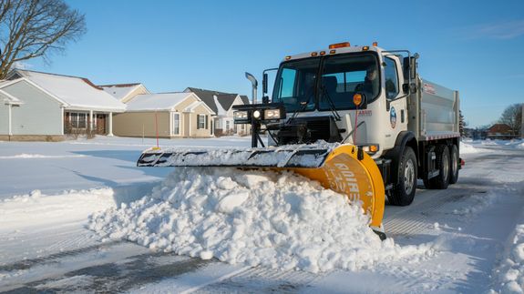 Yellow, Orange, and Black Truck Plowing Snow