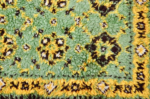 Top view of abstract backdrop representing colorful soft rug with geometric decor in daylight
