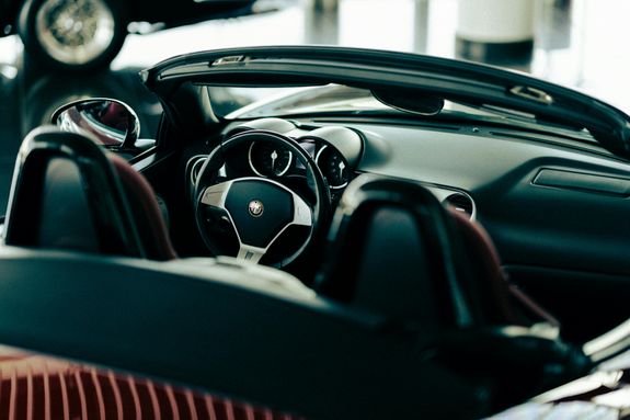 A car interior with a steering wheel and dashboard