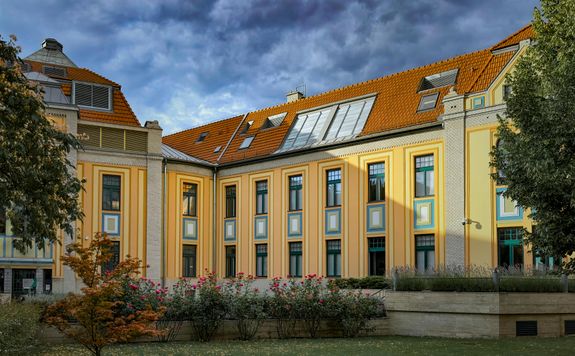 A building with a large yellow roof and a clock tower