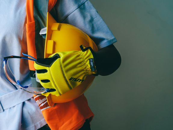 Close Up Photo of Person Holding Hardhat 