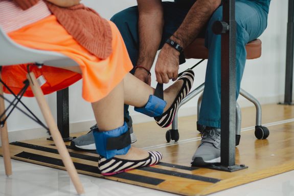 Man Wearing Bracelets on Woman Legs