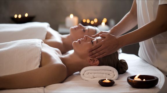Person Lying in Bed Getting Massage