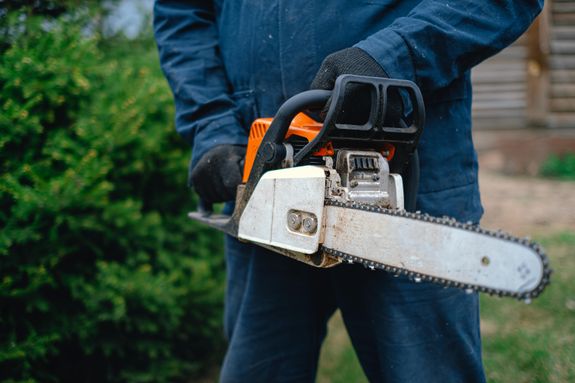A Person Holding a Chainsaw