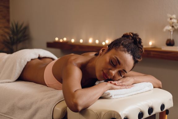 Woman Having a Massage with Massage Stones 