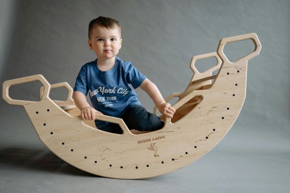 Boy in Blue T-Shirt Sitting in Wooden Toy