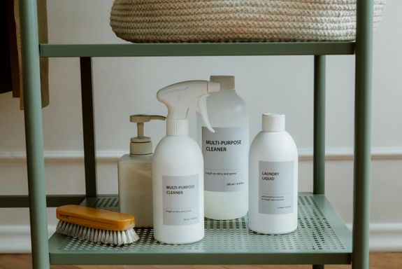 Bottles of Cleaning Products Standing on Metal Shelf