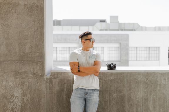 Young man standing by wall