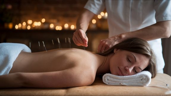 Person's Shoulder With an Acupuncture Needle