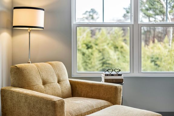 Armchair with Footstool and a Standing Room Lamp 