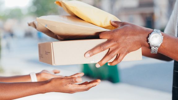 Person Handing Over Packages