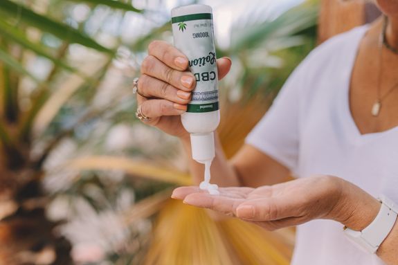 Person Holding White Plastic Bottle