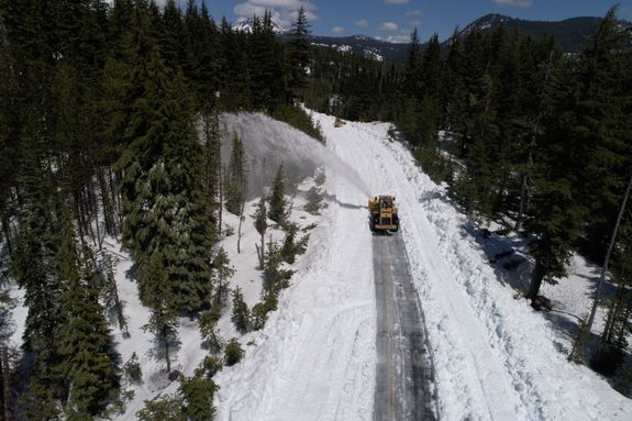 Snow Plough Removing Snow from Road
