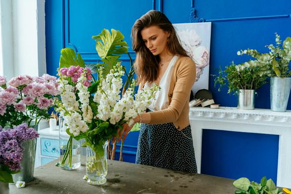 A Woman Arranging Flowers into the Vase