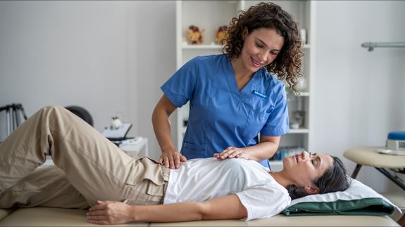 Physiotherapist Touching Womans Back 