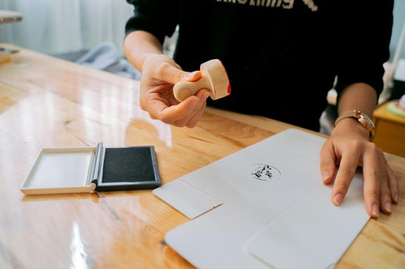 A Person Using a Stamp on a Paper