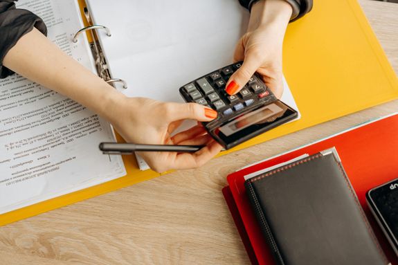 A Woman Computing with a Calculator