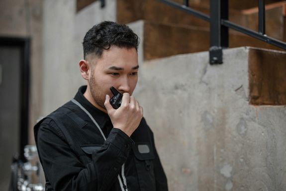 A Man Talking on a Walkie Talkie 
