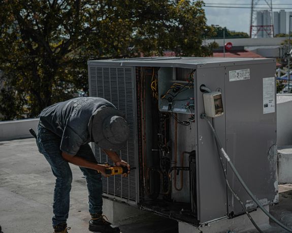 Man Drilling an Aircon Casing