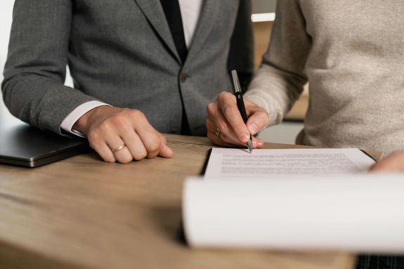 A Person Signing a Contract