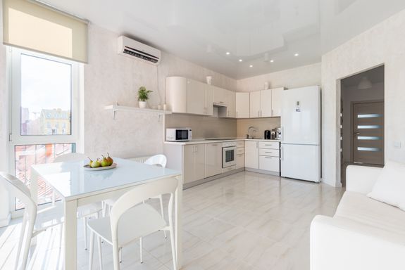 Interior of spacious light kitchen with dining zone