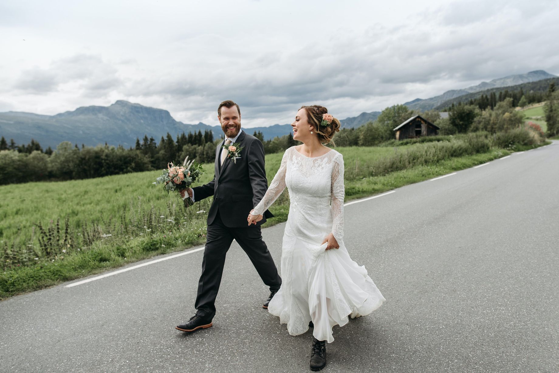A Bride and Groom Walking on the Road Hand in Hand
