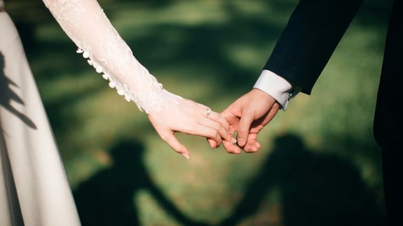 Man and Woman Walking of Body of Water