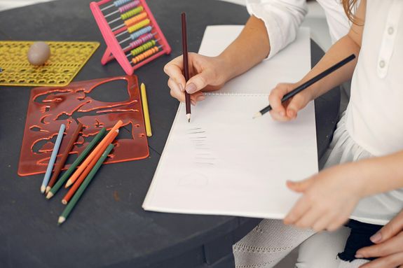 Crop schoolchild learning to count at home with tutor