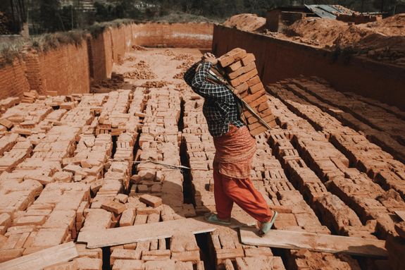 Person Carrying Bricks