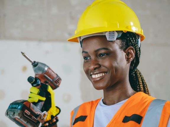 Smiling Woman Holding a Hand Grill 