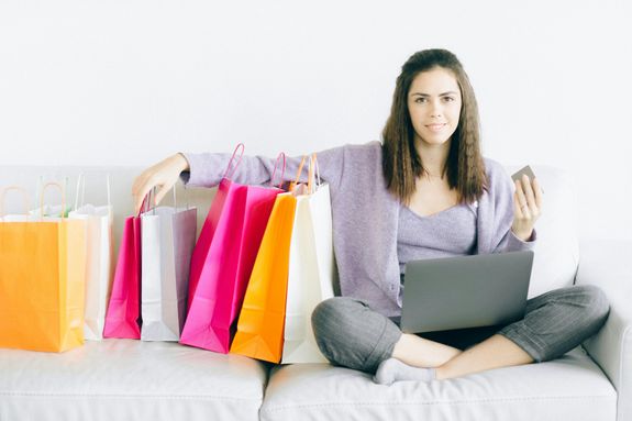 

A Woman Sitting on a Couch with Paper Bags
