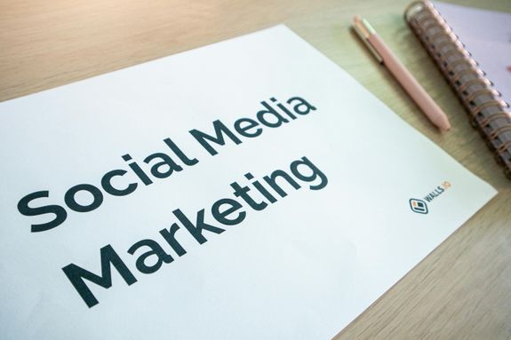 Desk with a a paper with the words Social Media Marketing on it and stationary elements