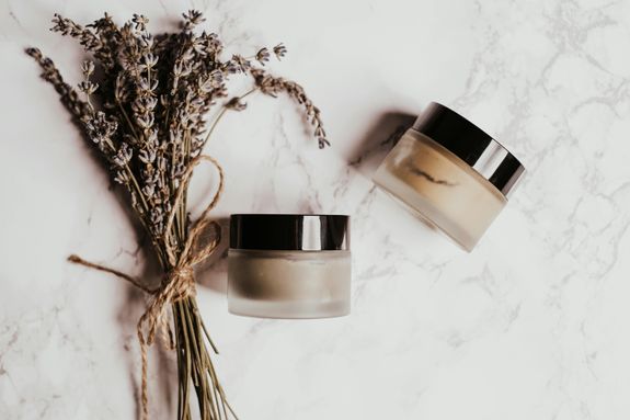 Dried Lavender Flowers Beside the Glass Cosmetic Jars 