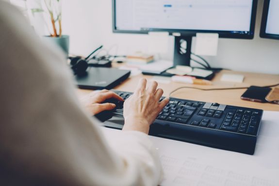 a person is typing on a computer keyboard