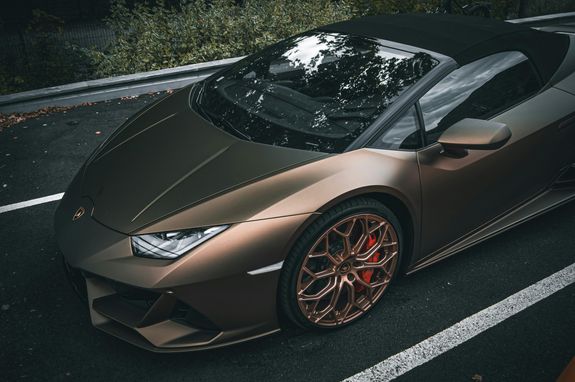 High angle view of a metallic Lamborghini Huracan convertible parked outdoors, showcasing elegance and luxury.