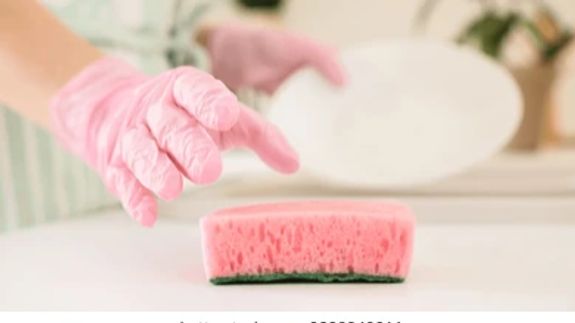 Person in Blue Gloves Cleaning White Sink