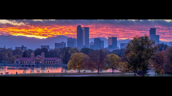 A close-up photograph of a black plastic garbage bag against a plain concrete wall, highlighting waste management.
