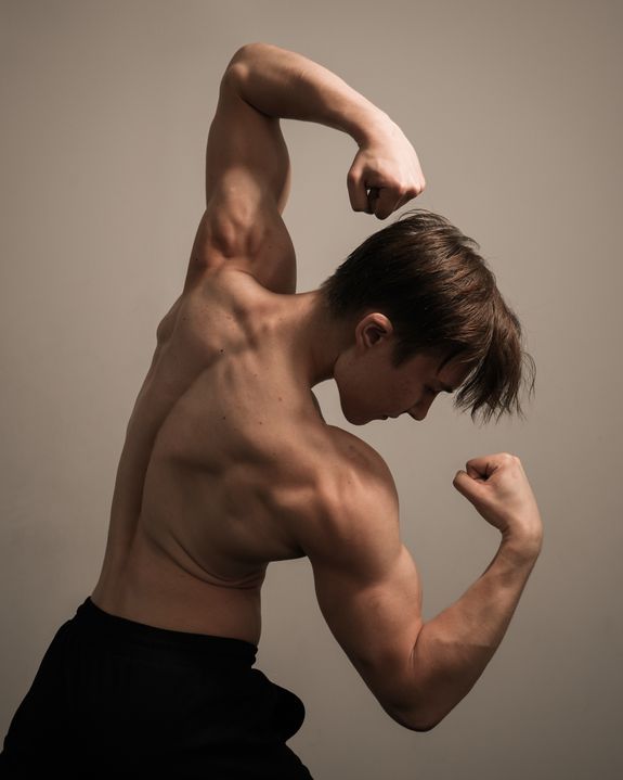 man running on road near grass field